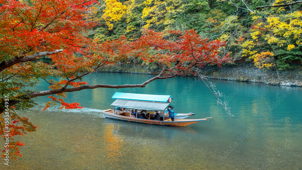 Naklejka premium People ride the Hozu River Boat Cruises in Katsura river in Arashiyama district