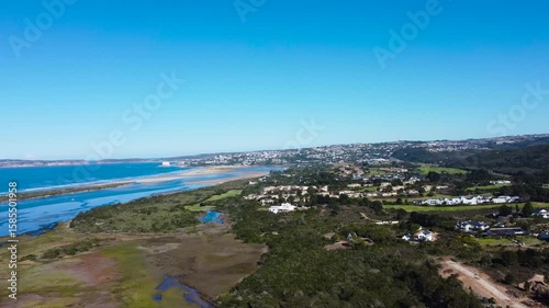 Camera approaching the Coastal Town of Plettenberg Bay and the mouth of the Keurbooms river and the ocean, 4K aerial video.