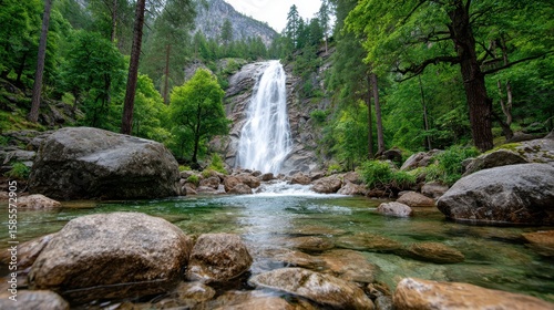 Majestic waterfall cascades through a lush forest under bright blue skies