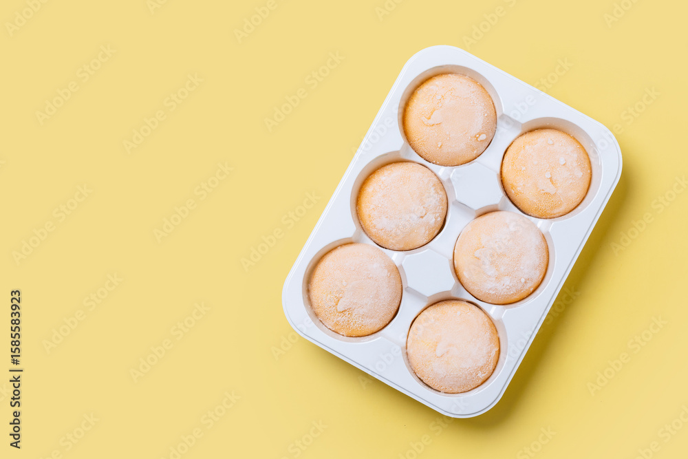Japanese Mango ice cream mochi on yellow background. Top view. Copy space Japanese Mango ice cream mochi on yellow background. Top view. Copy space