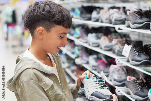 sales, back to school... preteen boy shopping, choosing sneakers