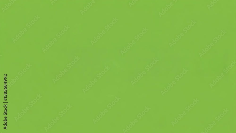 Studio-style over-ear matte black headphones placed upright on a solid chroma green surface, minimalist product shot, clear lighting and soft shadows, isolated on green background