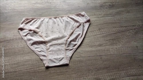 Classic women's underwear, cotton slip panties on a wooden background