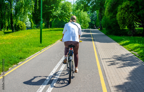 Wallpaper Mural Cyclist ride on the bike path in the city Park
 Torontodigital.ca