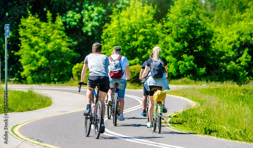 Cyclists ride on the bike path in the city Park
