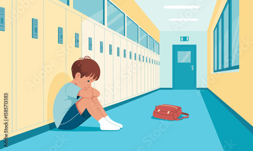 A sad boy sits alone on the floor in a school hallway with lockers, his backpack lies nearby.