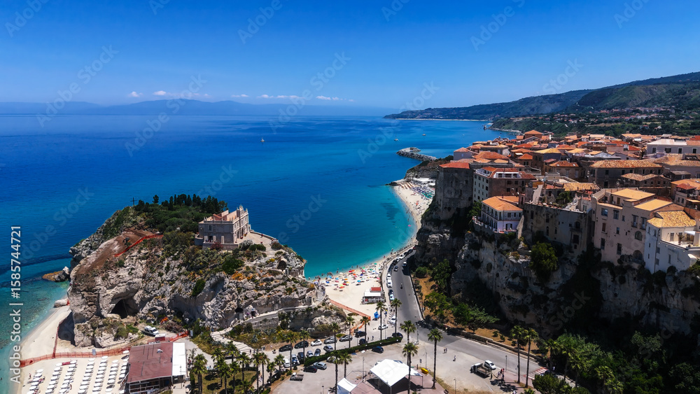 Naklejka premium Aerial view of Tropea, a charming town perched on a cliff overlooking the turquoise waters of the Tyrrhenian Sea in Calabria, Southern Italy
