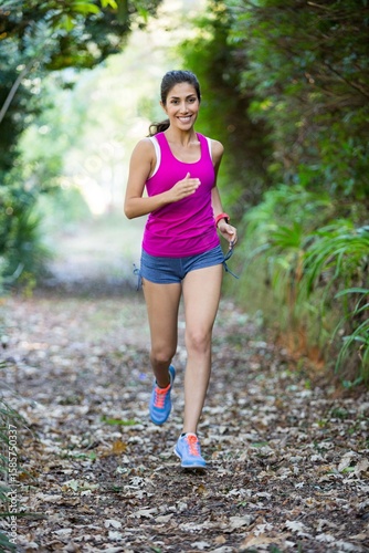 Portrait of happy woman jogging in field