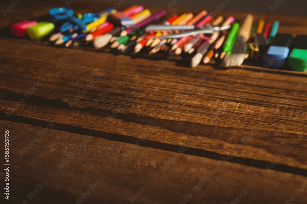 Naklejka premium High angle view of color pencils on wooden table