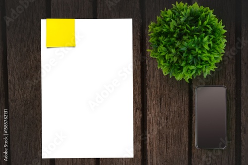 Table with a sheet of paper and a mobile phone