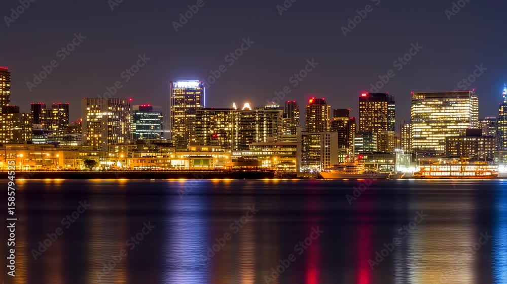 City skyline at night reflected in water City skyline at night reflected in water
