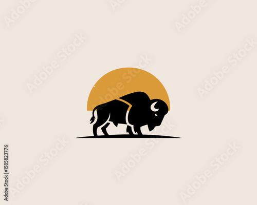 A bold silhouette of a buffalo stands majestically before a warm orange sunset, evoking feelings of strength and freedom in a minimalist design.