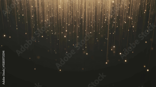 Golden light particles cascading down against a dark abstract backdrop falling