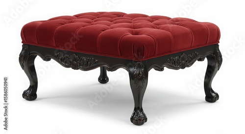 Luxurious deep red tufted ottoman with ornate carved dark wood legs