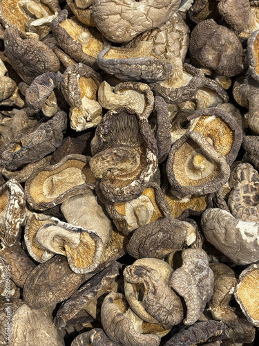 A pile of dehydrated whole mushroom, being sold in an Asian grocery store,