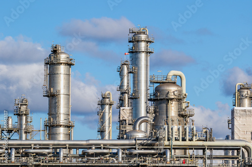 Pipes, pipelines, and cooling towers at an oil refinery power station infrastructure for energy production.