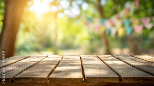 Beautiful outdoor scene with wooden table and vibrant decorations hanging in garden setting during daytime.