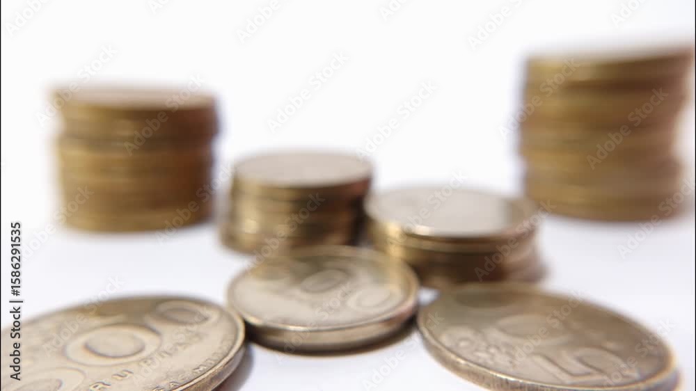 Time lapse of gold coins fading into white background, visual metaphor for disappearing savings or inflation. Business and financial concept Time lapse of gold coins fading into white background, visual metaphor for disappearing savings or inflation. Business and financial concept