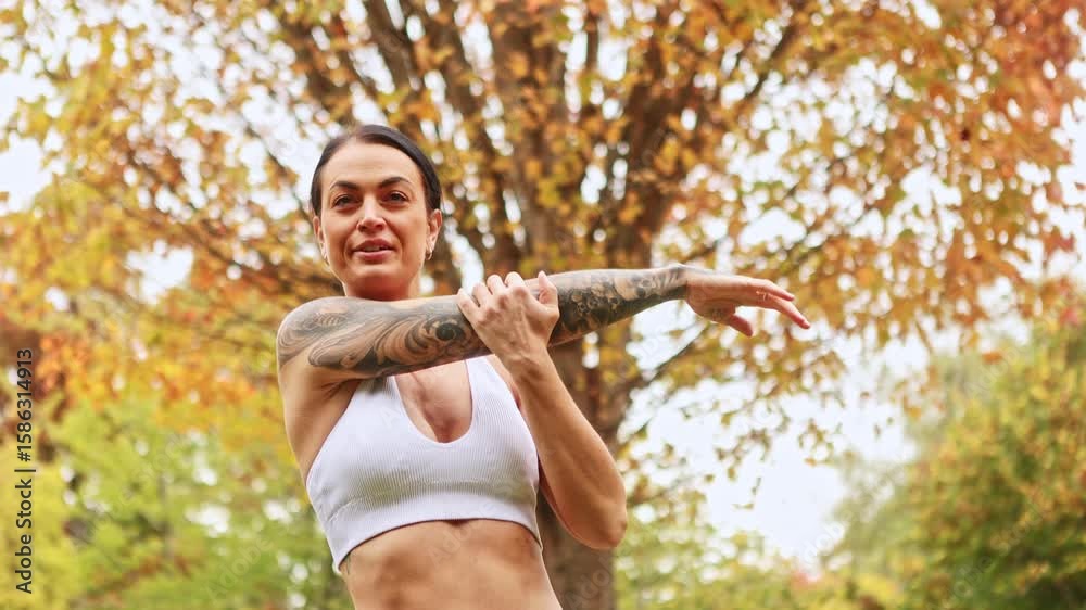 Woman exercising in autumn park in New Zealand