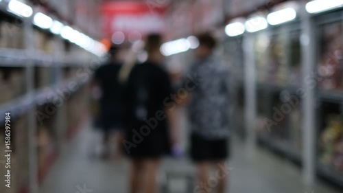 Wallpaper Mural A blurry image of a grocery store with people shopping. Scene is busy and bustling, with people walking around and shopping for food Torontodigital.ca