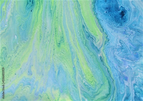 Abstract background of acrylic paint in blue and green tones. Liquid marble pattern.