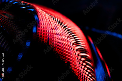 Curved wave of circular bokeh dots in red and blue on dark background – glowing abstract pattern for digital design, technology, AI, science, and creative visual communication applications
