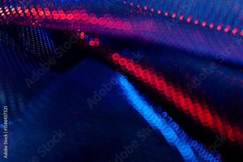 Abstract red and blue bokeh lights in wave formation on dark background – glowing defocused particles for futuristic technology, energy, AI, science, digital art and visual design concepts
