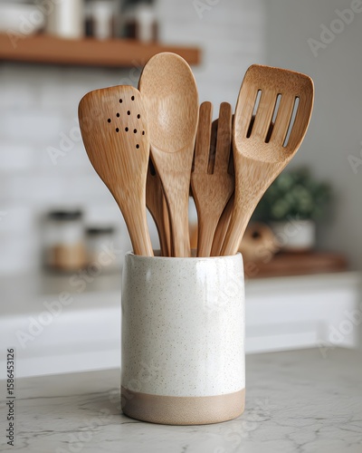 Bamboo tools in rustic kitchen crock container high resolution picture