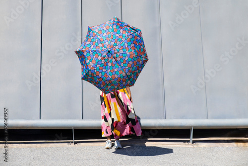 Vibrant umbrella against modern architectural backdrop