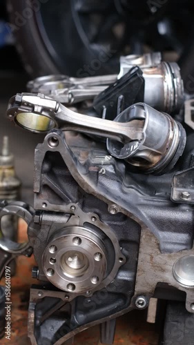 Wallpaper Mural A car engine is being worked on with a wrench. The engine is black and has a lot of parts Torontodigital.ca