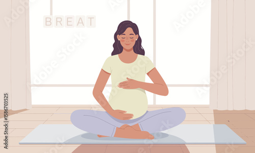 Pregnant woman meditating in lotus position on a yoga mat, indoors, with "BREATHE" blocks in the background near a bright window.