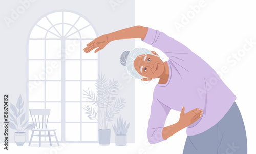 An elderly woman with grey hair is stretching her body to the side in a bright, airy room with plants and a large window.