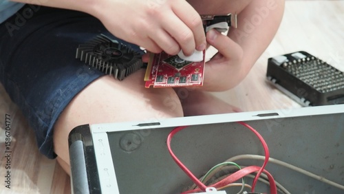 technician hold the screwdriver for repairing the laptop. computer hardware, repairing, upgrade and technology. professional technicial at workplace concentrated. focus on hands