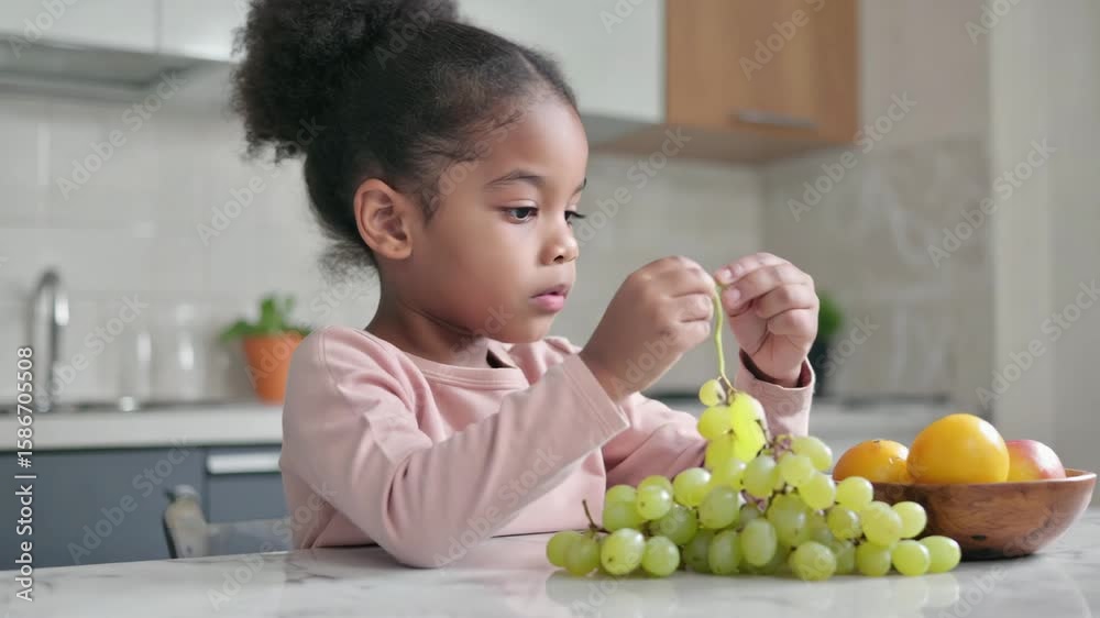 Happy Child Chewing Green Grapes – Natural Moment of Healthy Eating

