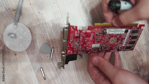 technician hold the screwdriver for repairing the laptop. computer hardware, repairing, upgrade and technology. professional technicial at workplace concentrated. focus on hands