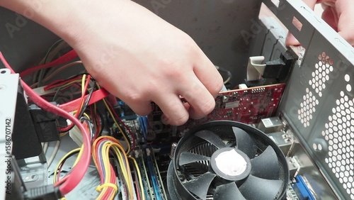 technician hold the screwdriver for repairing the laptop. computer hardware, repairing, upgrade and technology. professional technicial at workplace concentrated. focus on hands