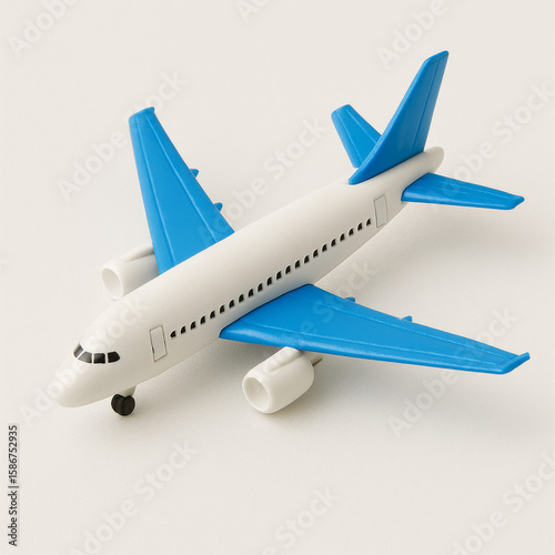 Toy airplane with blue wings isolated on white — playful aviation cutout for travel, childhood, and imagination themes