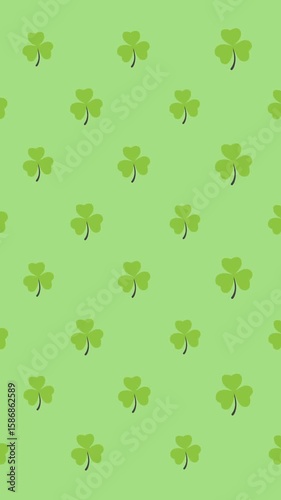 Digital animation of multiple clover leaves moving against green background