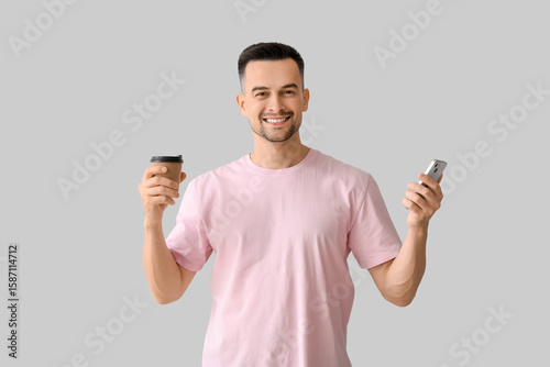 Happy young man with cup of...