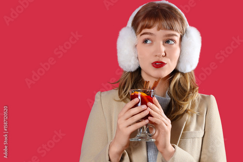 Young woman in earmuffs wit...