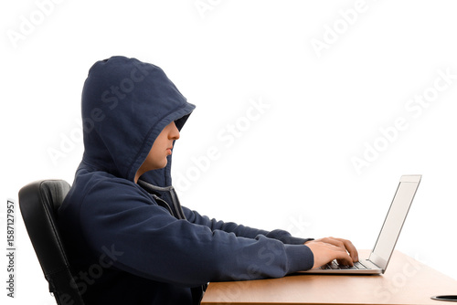 Hacker using laptop at tabl...
