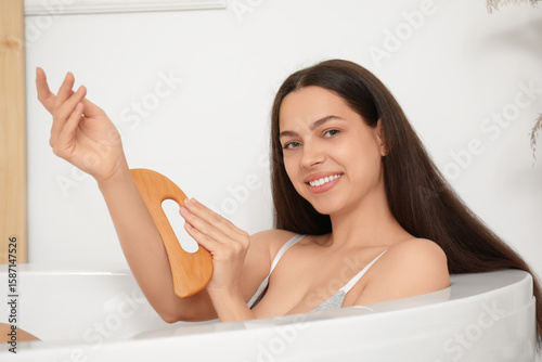 Young woman using wooden gu...