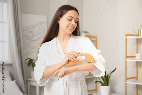 Young woman massaging her a...