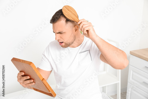 Worried young man with hair...
