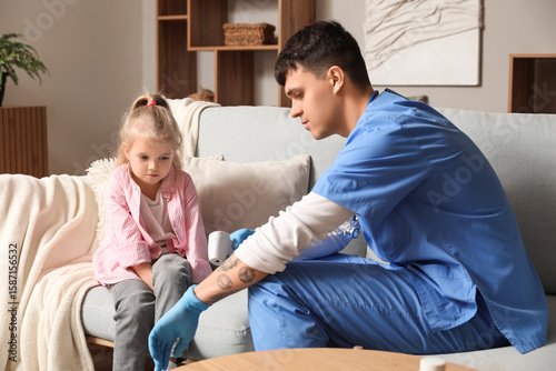 Male pediatrician with litt...