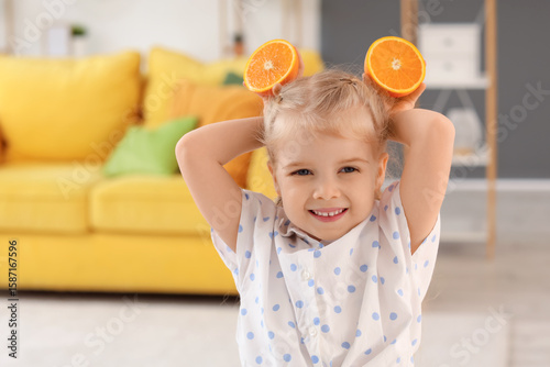 Cute little girl with orang...