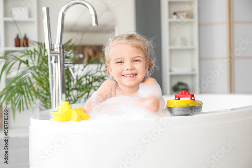 Cute little girl with toys ...