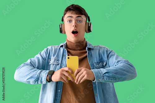 Shocked young man in headph...