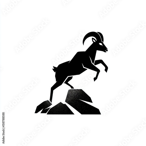 Silhouette of a leaping goat atop rocks