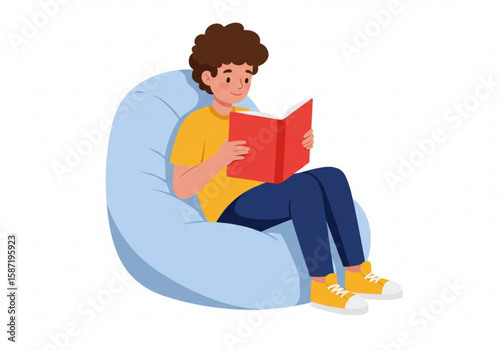 Young boy happily reading a book while sitting comfortably in a beanbag chair